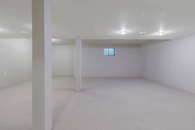 basement featuring light colored carpet