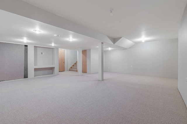 basement featuring light colored carpet