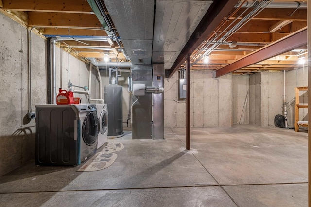 basement featuring heating unit, electric panel, separate washer and dryer, and water heater