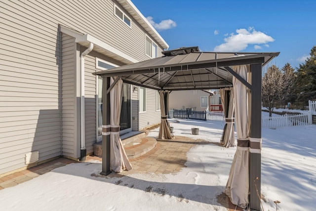 snow covered patio with a gazebo