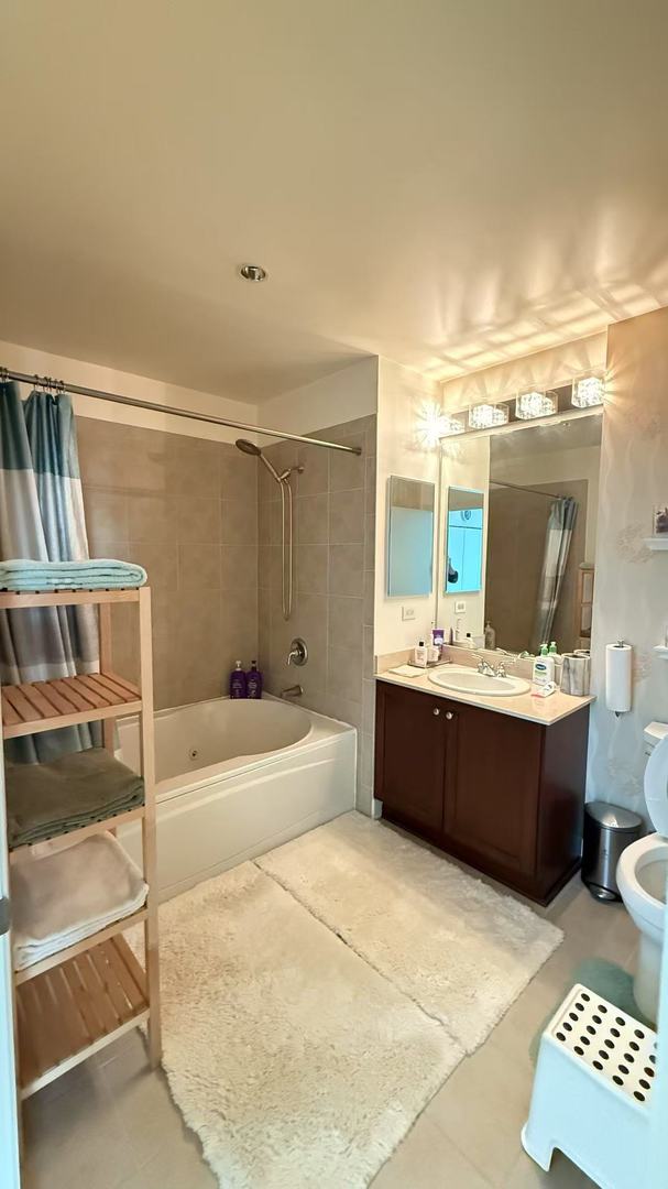 full bathroom with shower / bath combo, vanity, and toilet