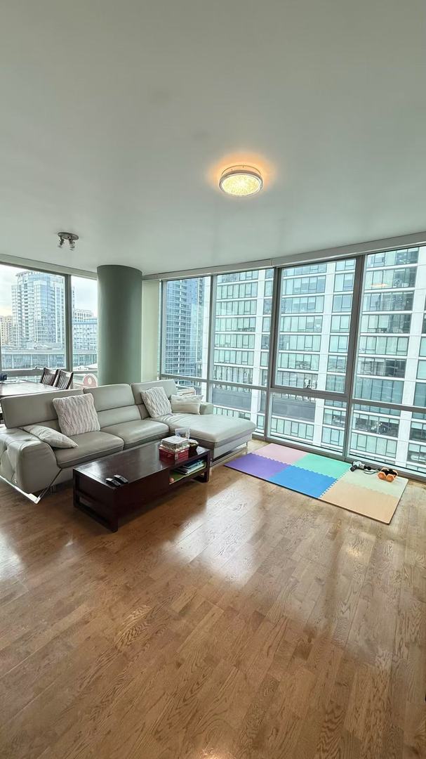 unfurnished living room featuring hardwood / wood-style floors and expansive windows