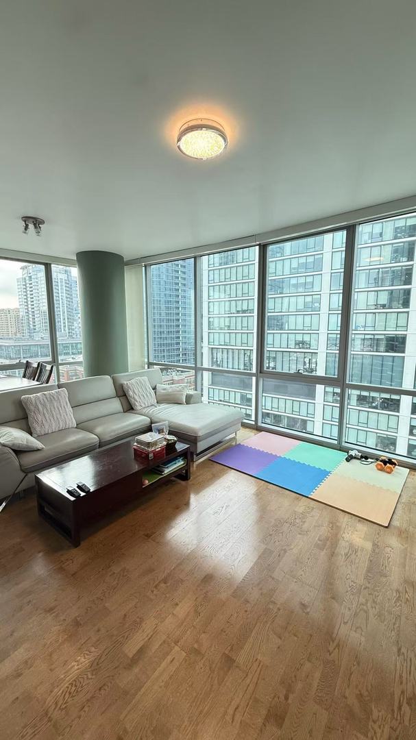 living room with hardwood / wood-style floors and expansive windows