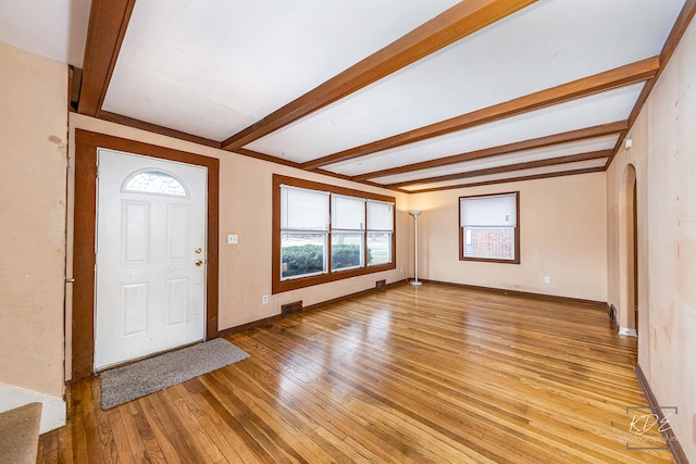 entrance foyer with beam ceiling and light hardwood / wood-style floors