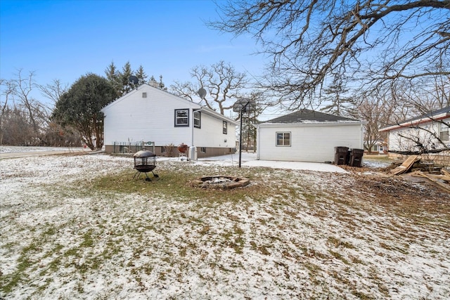 snow covered house with an outdoor fire pit