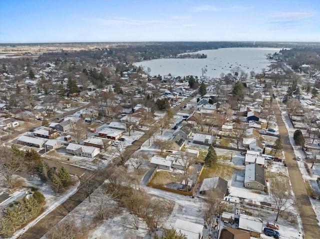 snowy aerial view featuring a water view