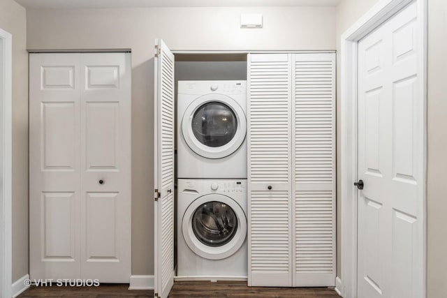 washroom featuring dark hardwood / wood-style floors and stacked washer and clothes dryer