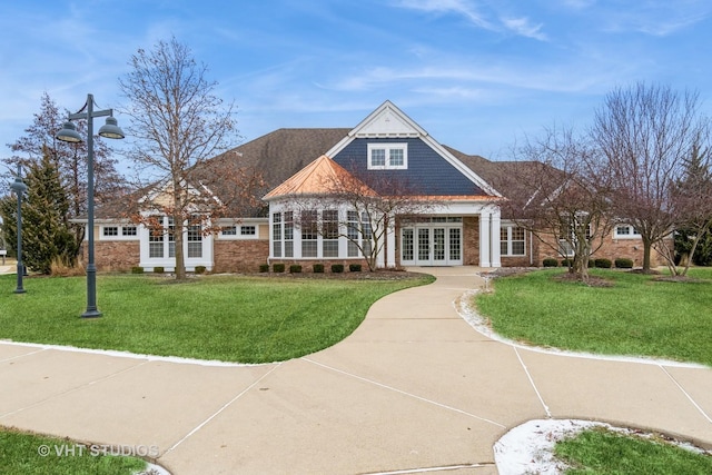 exterior space featuring french doors and a front lawn