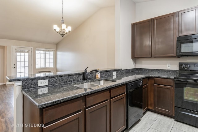 kitchen featuring kitchen peninsula, vaulted ceiling, sink, black appliances, and dark stone countertops