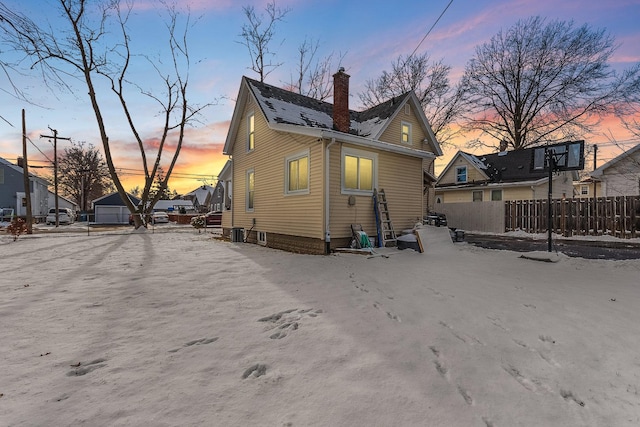 view of back house at dusk