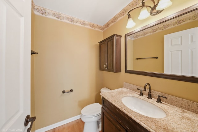 bathroom featuring hardwood / wood-style flooring, vanity, and toilet