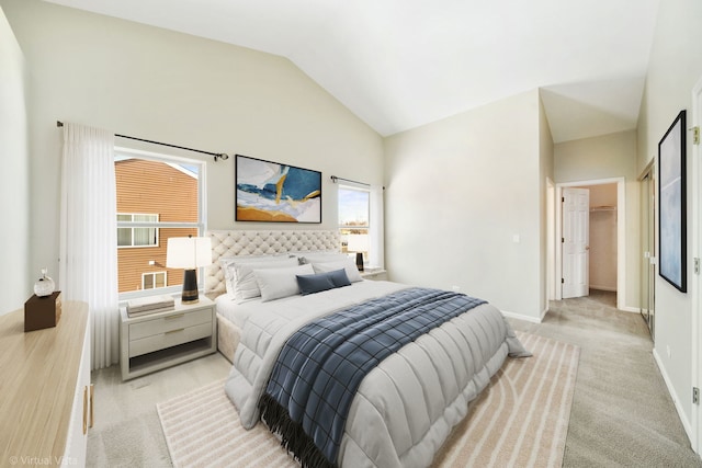 carpeted bedroom featuring a spacious closet and vaulted ceiling