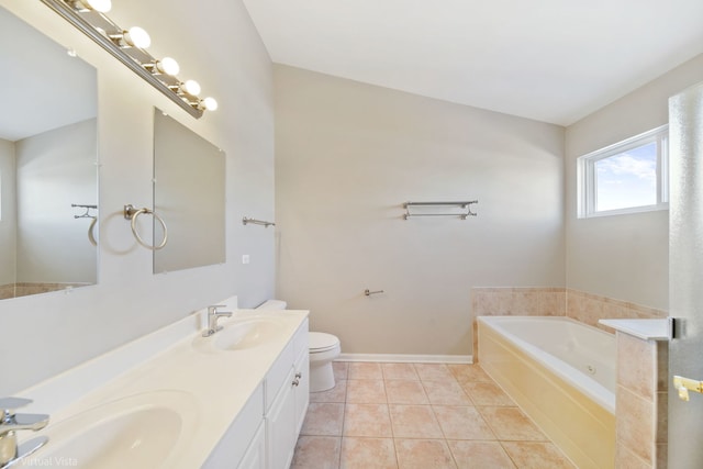 bathroom featuring toilet, tile patterned floors, a bath, and vanity