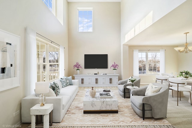 living room with a notable chandelier and a high ceiling