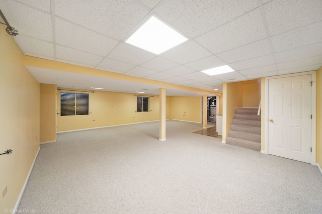 basement featuring carpet and a drop ceiling