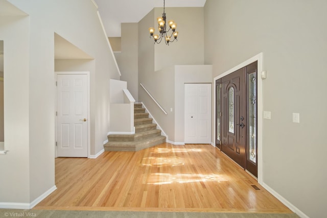 foyer entrance featuring an inviting chandelier and wood-type flooring