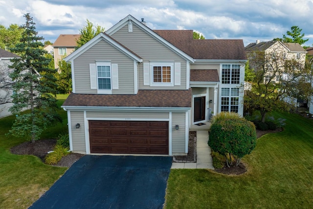 view of front of property featuring a front lawn and a garage