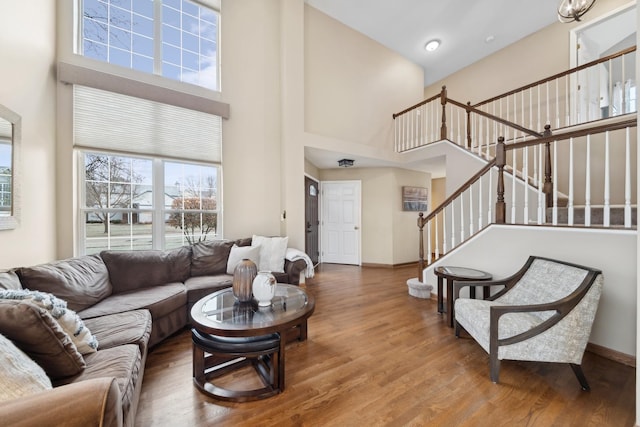 living room with a high ceiling and hardwood / wood-style floors