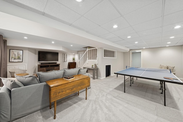 playroom featuring a paneled ceiling and light carpet