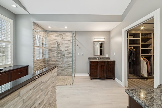 bathroom featuring vanity and a shower with shower door