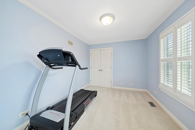 workout room with ornamental molding and light carpet