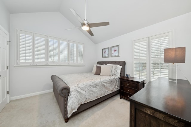 bedroom featuring multiple windows, light carpet, ceiling fan, and vaulted ceiling