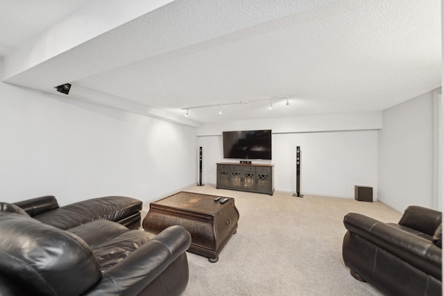 living room featuring light colored carpet, track lighting, and a textured ceiling