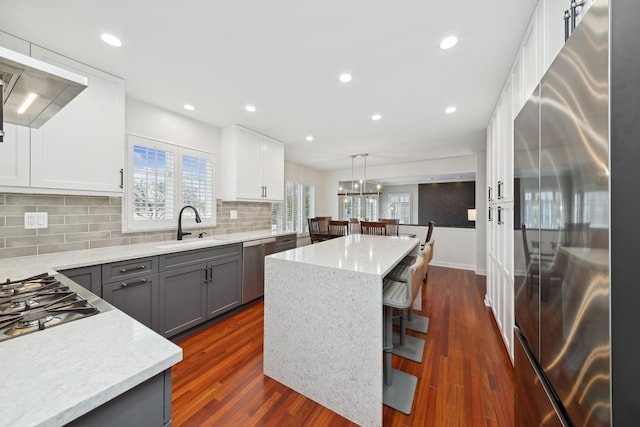 kitchen featuring sink, gray cabinetry, a center island, pendant lighting, and stainless steel appliances