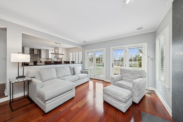 living room with dark wood-type flooring and crown molding