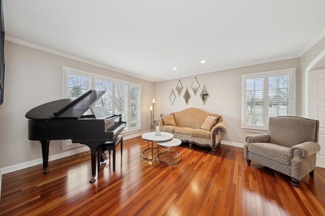 sitting room featuring ornamental molding, a healthy amount of sunlight, and hardwood / wood-style floors