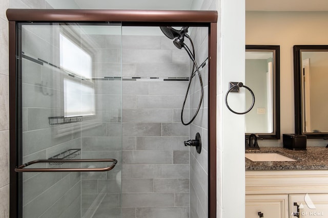 bathroom featuring vanity and an enclosed shower