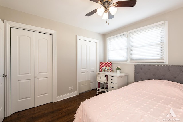 bedroom with multiple closets, ceiling fan, and dark wood-type flooring