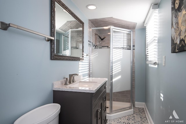 bathroom featuring tile patterned flooring, vanity, an enclosed shower, and toilet