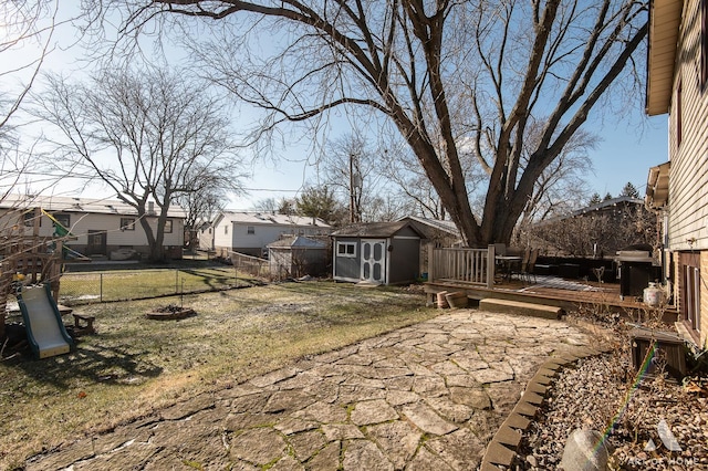 view of yard with a storage unit and a wooden deck