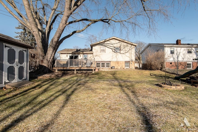 view of yard featuring a wooden deck and a shed