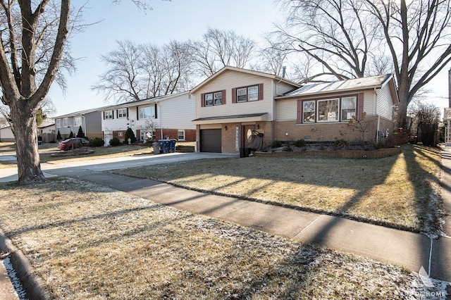 view of front of home with a front lawn and a garage