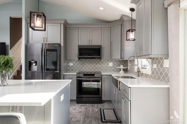 kitchen with gray cabinetry, sink, pendant lighting, and appliances with stainless steel finishes