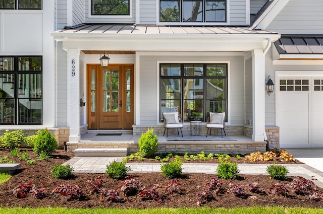 property entrance with a garage and covered porch