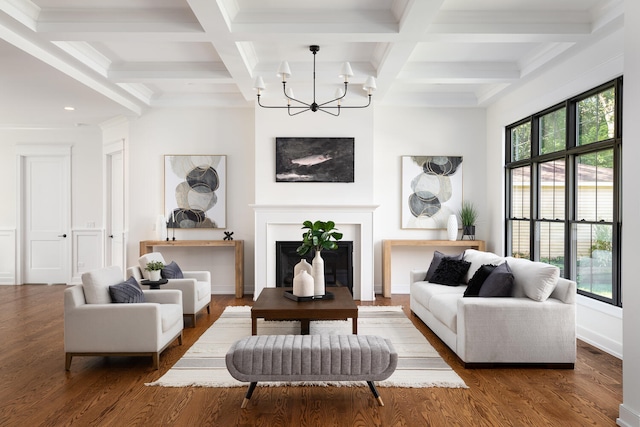 living room featuring beamed ceiling, dark hardwood / wood-style flooring, an inviting chandelier, and coffered ceiling