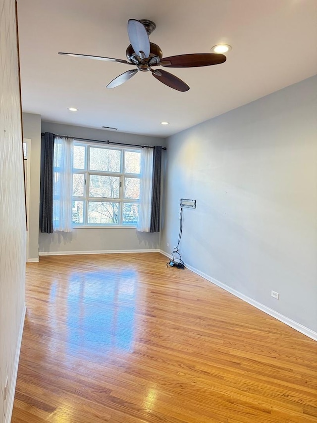 spare room featuring ceiling fan and light hardwood / wood-style floors