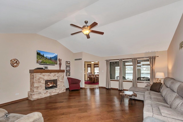 living room featuring a fireplace, dark hardwood / wood-style floors, ceiling fan, and a healthy amount of sunlight