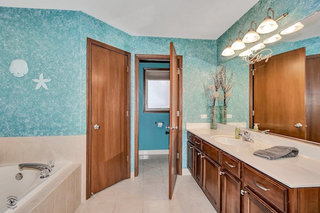 bathroom with tile patterned flooring, vanity, and a relaxing tiled tub