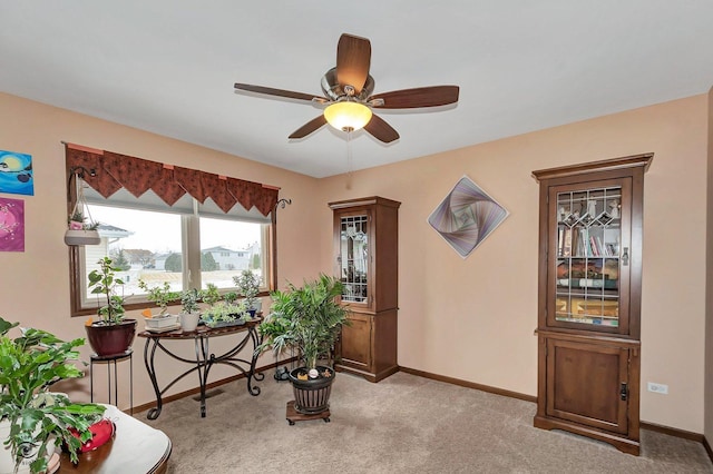 misc room featuring light carpet and ceiling fan