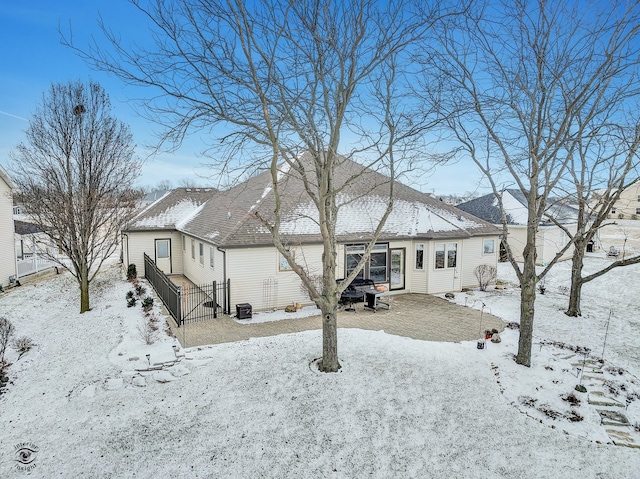 snow covered property featuring cooling unit