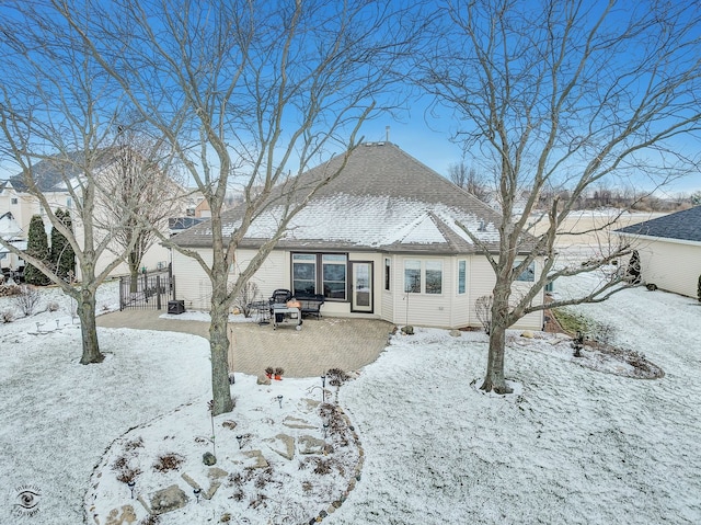 view of snow covered back of property