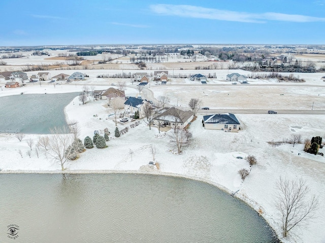 snowy aerial view featuring a water view