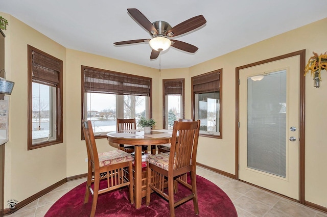 tiled dining room with ceiling fan