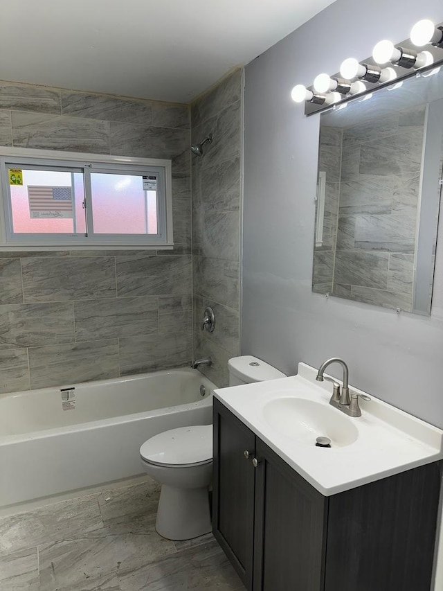 full bathroom with tiled shower / bath combo, toilet, and vanity