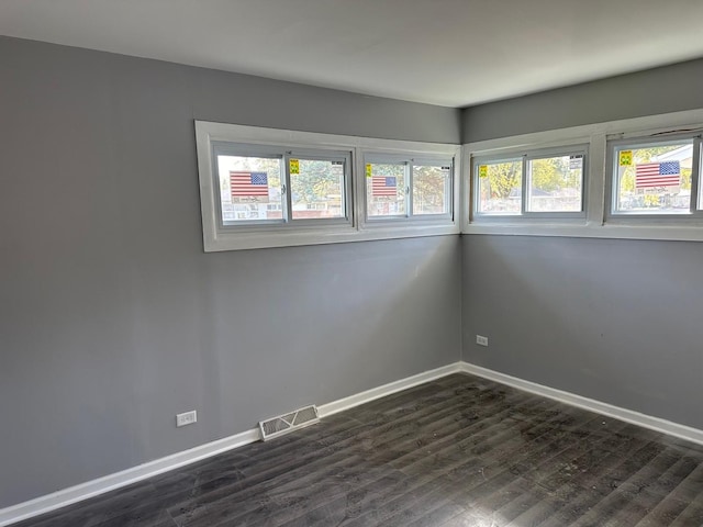 unfurnished room featuring dark hardwood / wood-style floors