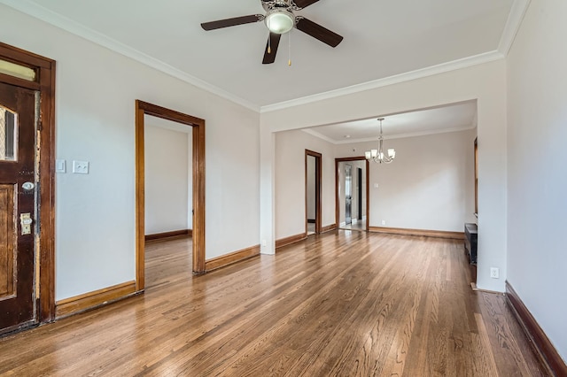 spare room featuring hardwood / wood-style flooring, ceiling fan with notable chandelier, and crown molding